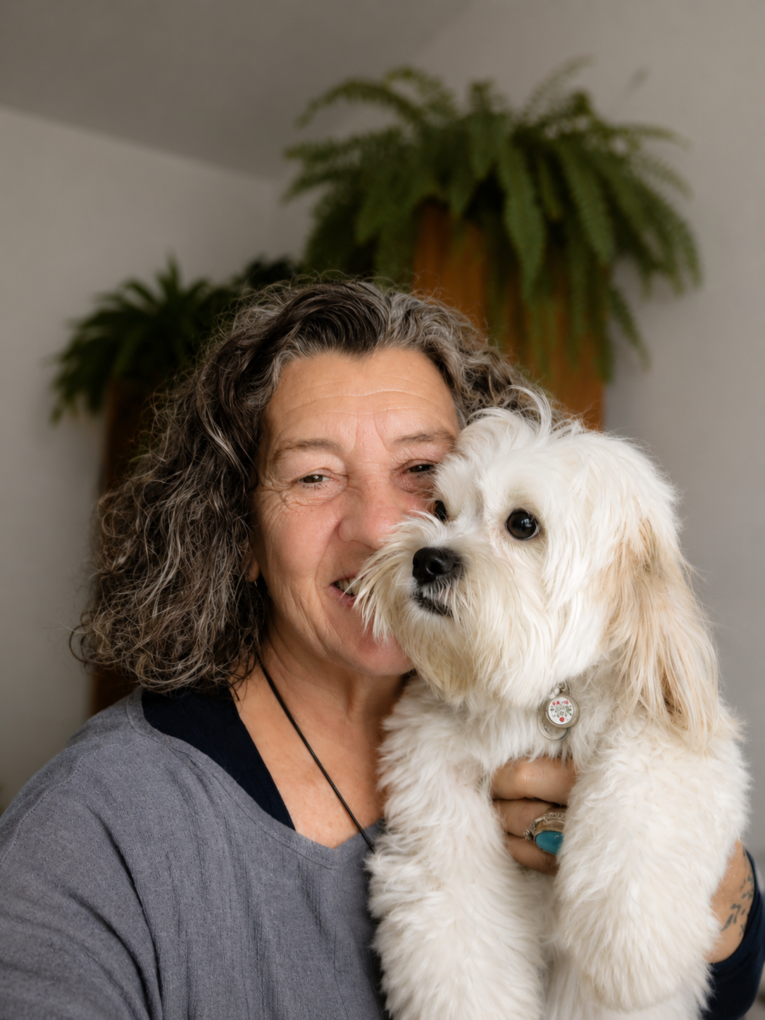 Carmen com cão branco pequeno no colo